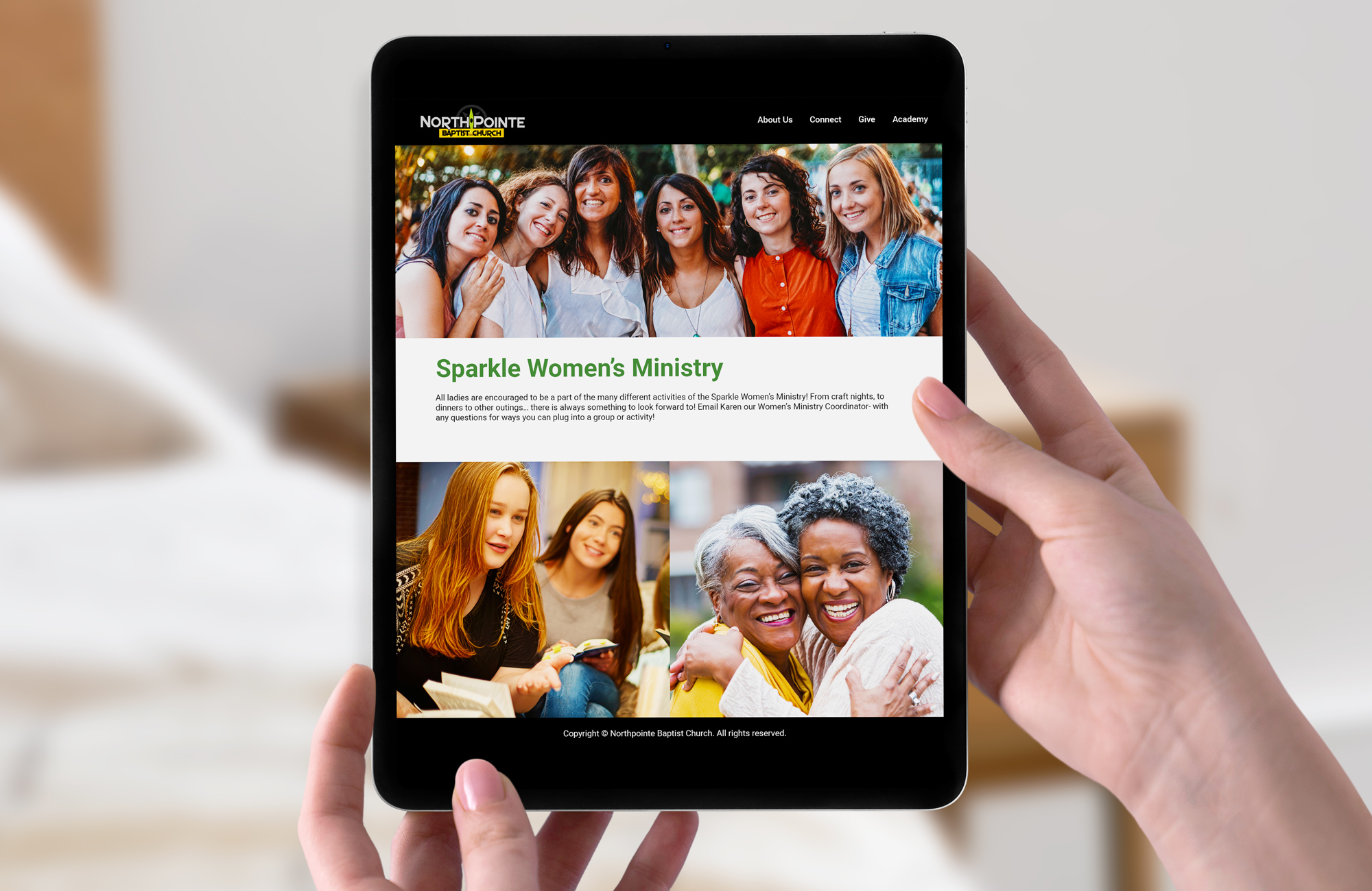 Hands holding a tablet displaying Sparkle Women's Ministry page layout with community photo galleries and event information.